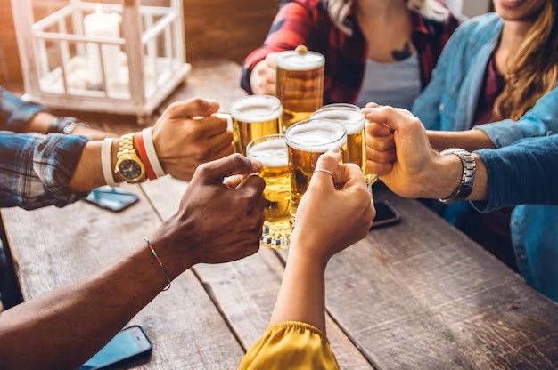 Friends toasting beers at Camden Sports Club