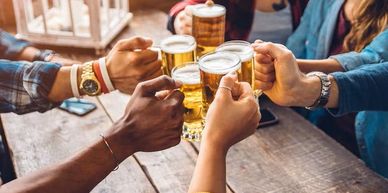 Friends enjoying cold beers at the bar